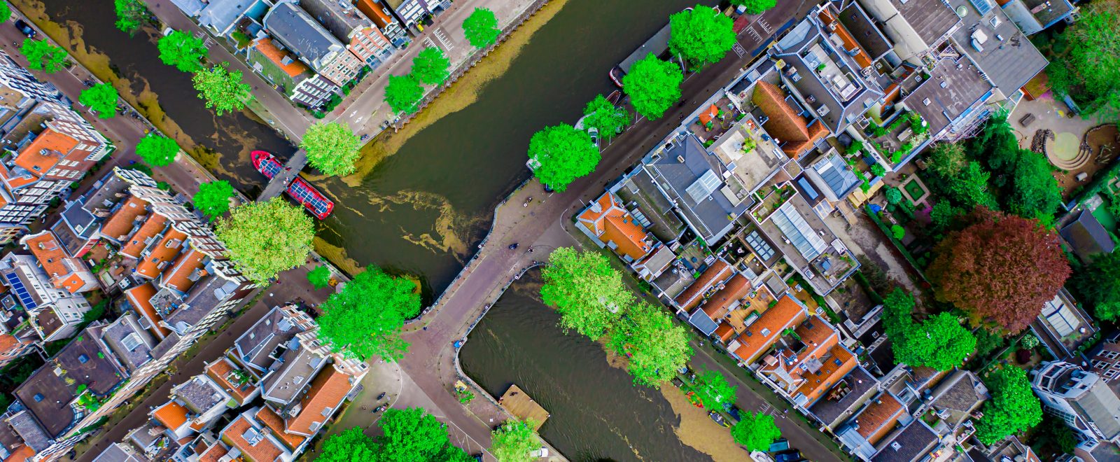 Aerial drone top down photo of Amsterdam canals with leisure boa