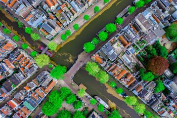 Aerial drone top down photo of Amsterdam canals with leisure boa