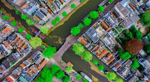 Aerial drone top down photo of Amsterdam canals with leisure boa