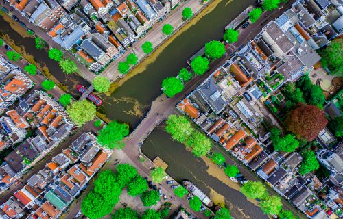 Aerial drone top down photo of Amsterdam canals with leisure boa