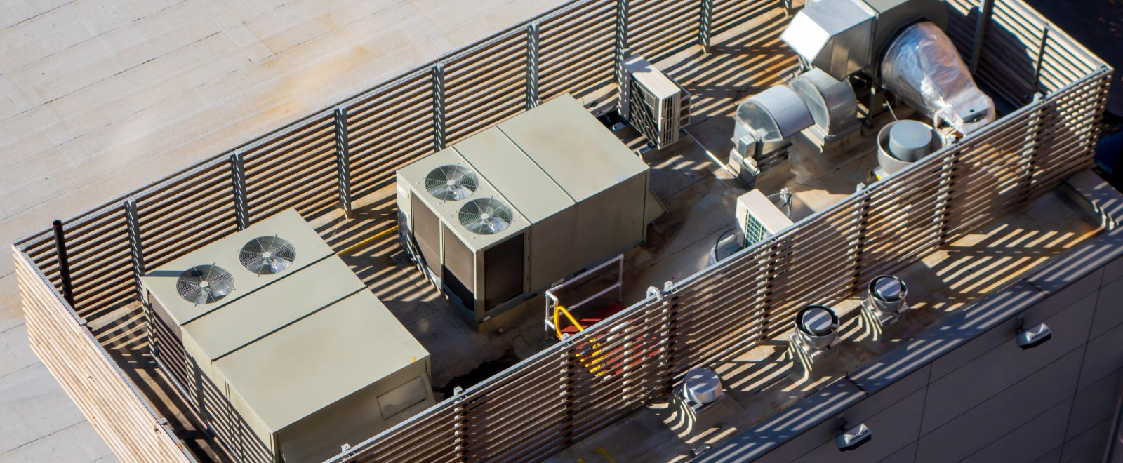 high angle birds-eye view of Manhattan New York City building rooftop with central ac units and ventilation