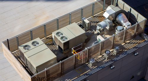 high angle birds-eye view of Manhattan New York City building rooftop with central ac units and ventilation