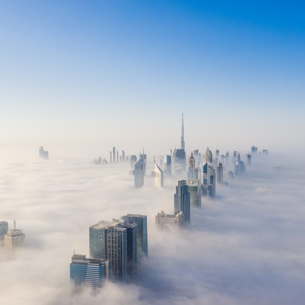 Aerial view of Dubai frame and skyline covered in dense fog during winter season