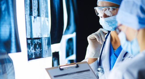 Two female women medical doctors looking at x-rays in a hospital