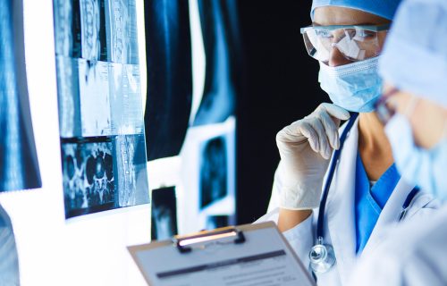 Two female women medical doctors looking at x-rays in a hospital