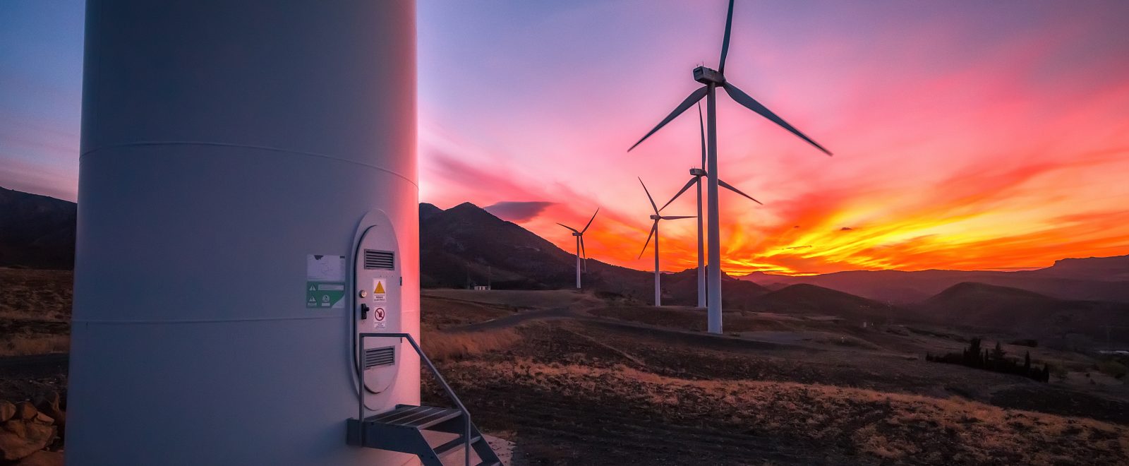 Colorful sunset with wind turbines