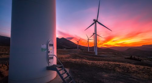 Colorful sunset with wind turbines