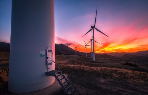 Colorful sunset with wind turbines