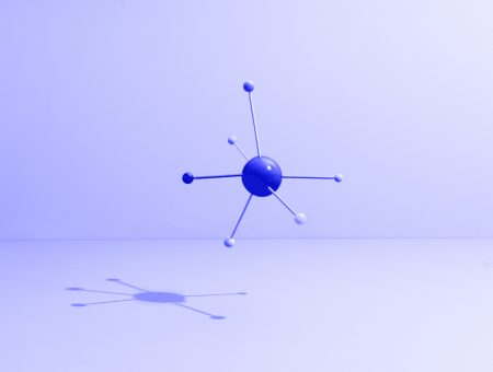 Conceptual still life with colored sticks attached to a sphere, symbolizing teamwork