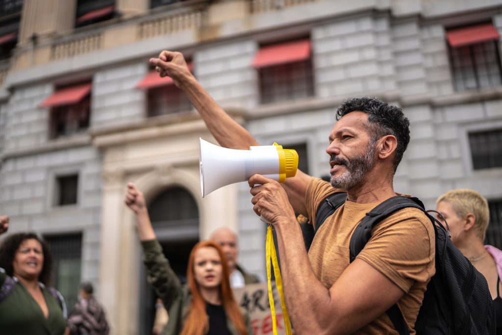 Man leading a demonstration using a megaphone