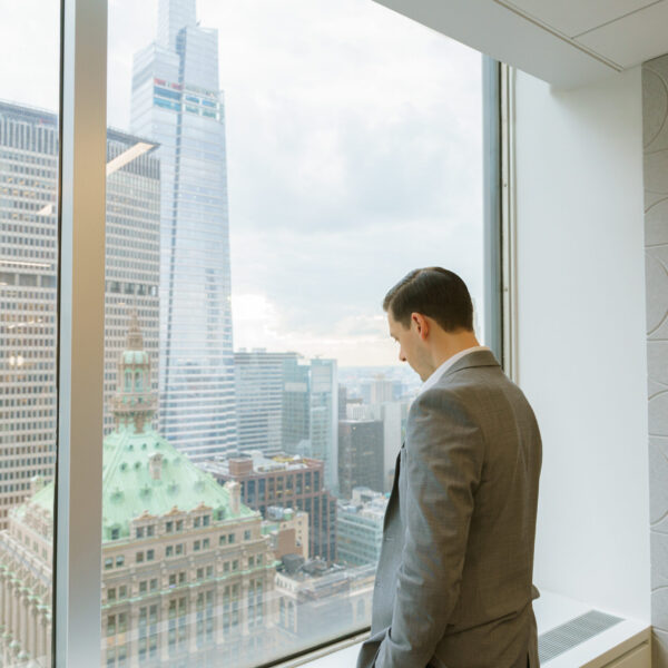 ICG employee looking out of window from 277 Park Avenue, our office in New York City