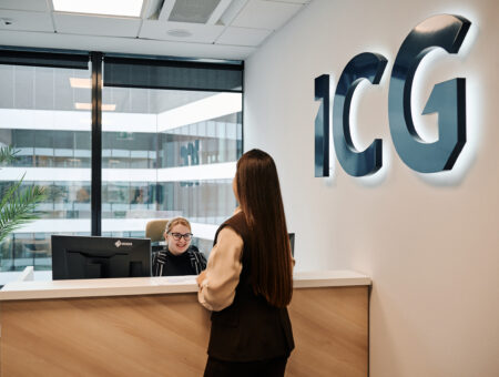 Colleagues speaking at the Reception desk in ICG's office in Warsaw, Poland