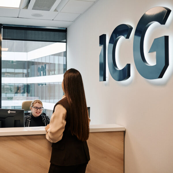 Colleagues speaking at the Reception desk in ICG's office in Warsaw, Poland