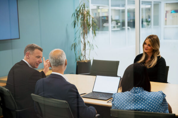 Colleagues gather around a table in ICG's London office