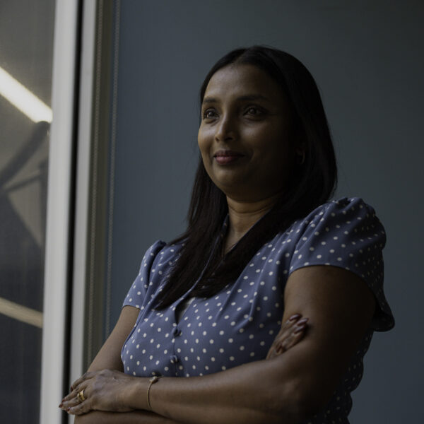 Women standing with arms folded