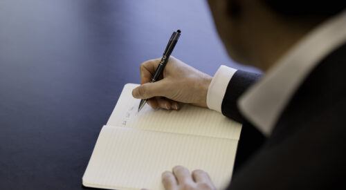 Man writing in a notebook