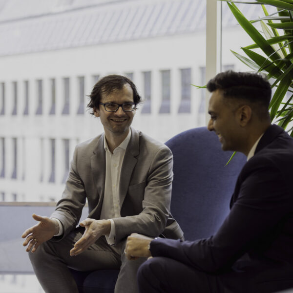Two men, sat down in conversation