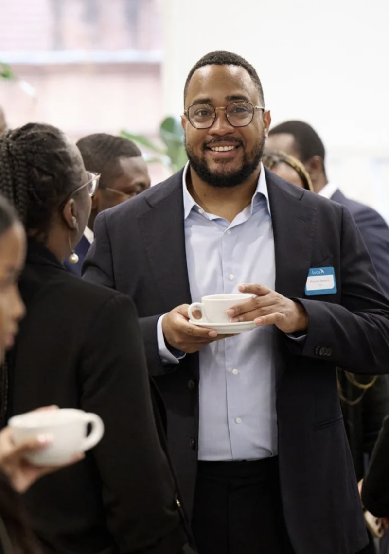 Man drinking coffee at networking event
