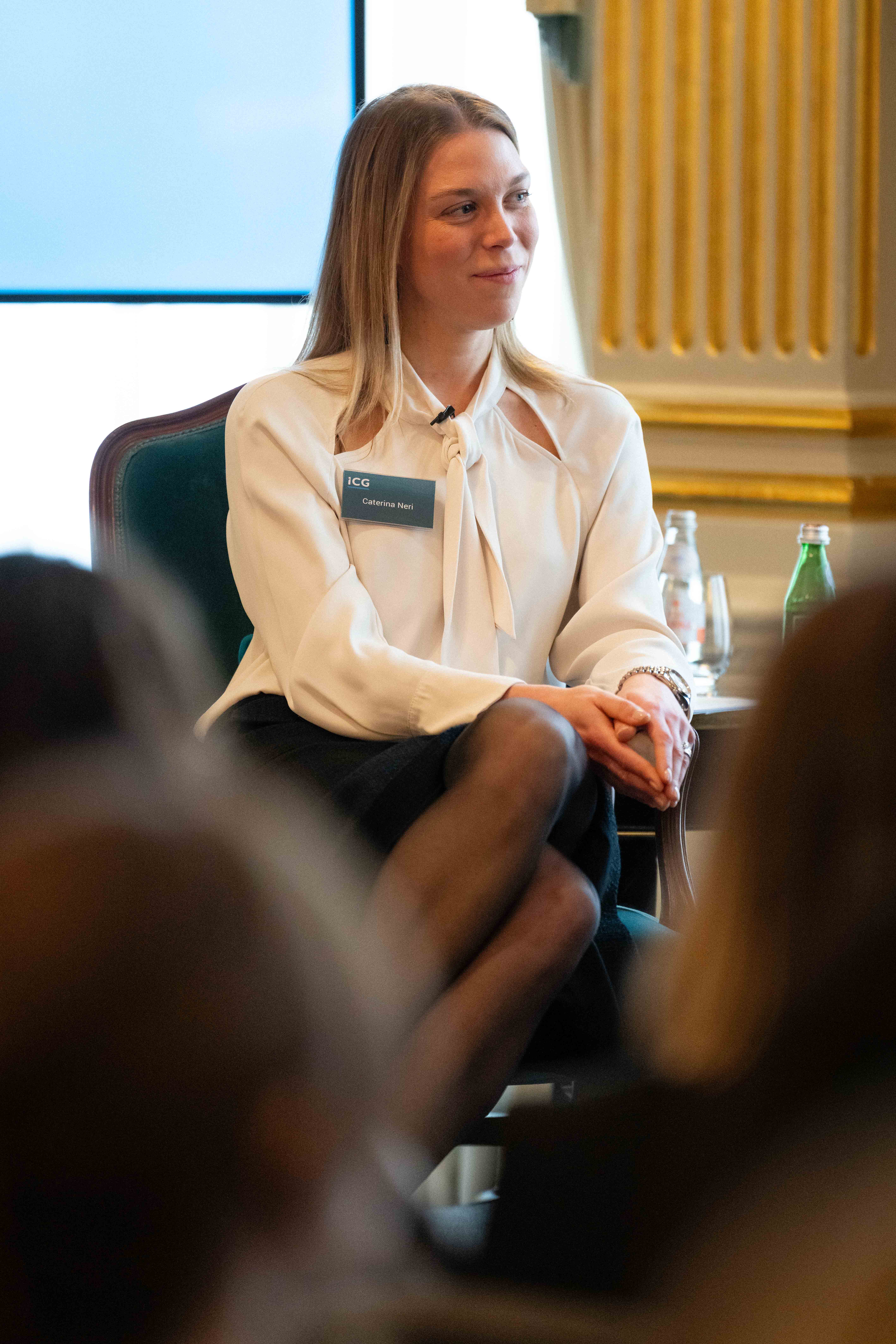 Woman sitting in chair, listening