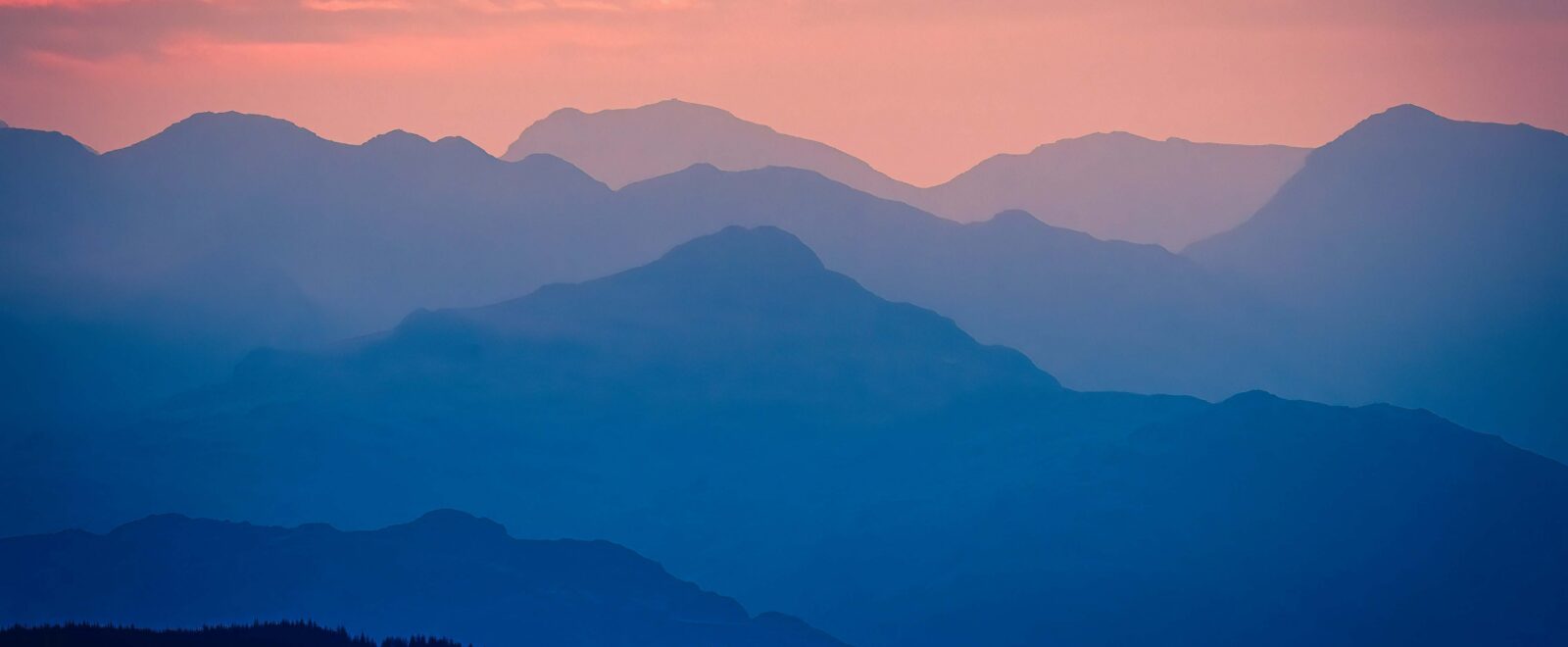 Mountains under a pink sky -- this image is used on the front cover of ICG's Sustainability and People Report 2026