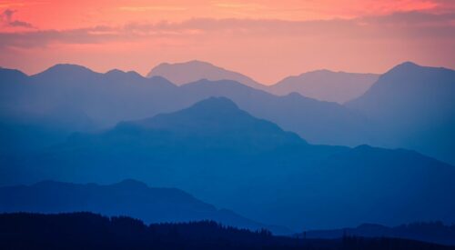 Mountains under a pink sky -- this image is used on the front cover of ICG's Sustainability and People Report 2026