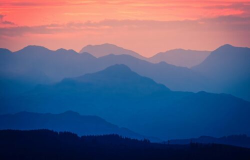 Mountains under a pink sky -- this image is used on the front cover of ICG's Sustainability and People Report 2026