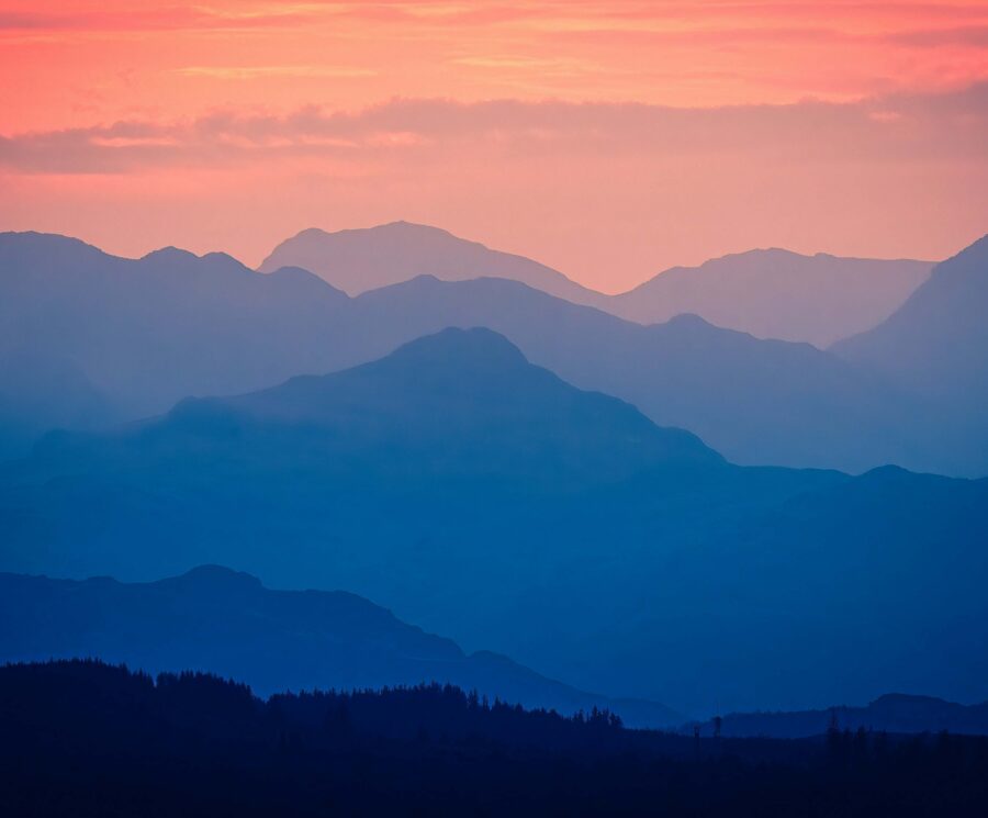 Mountains under a pink sky -- this image is used on the front cover of ICG's Sustainability and People Report 2026