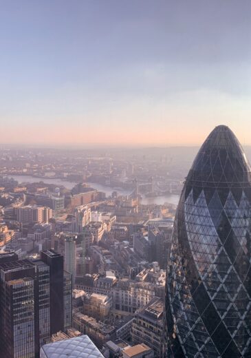 The London skyline with the Gherkin building and the Thames River at low sun