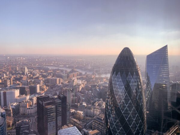 The London skyline with the Gherkin building and the Thames River at low sun